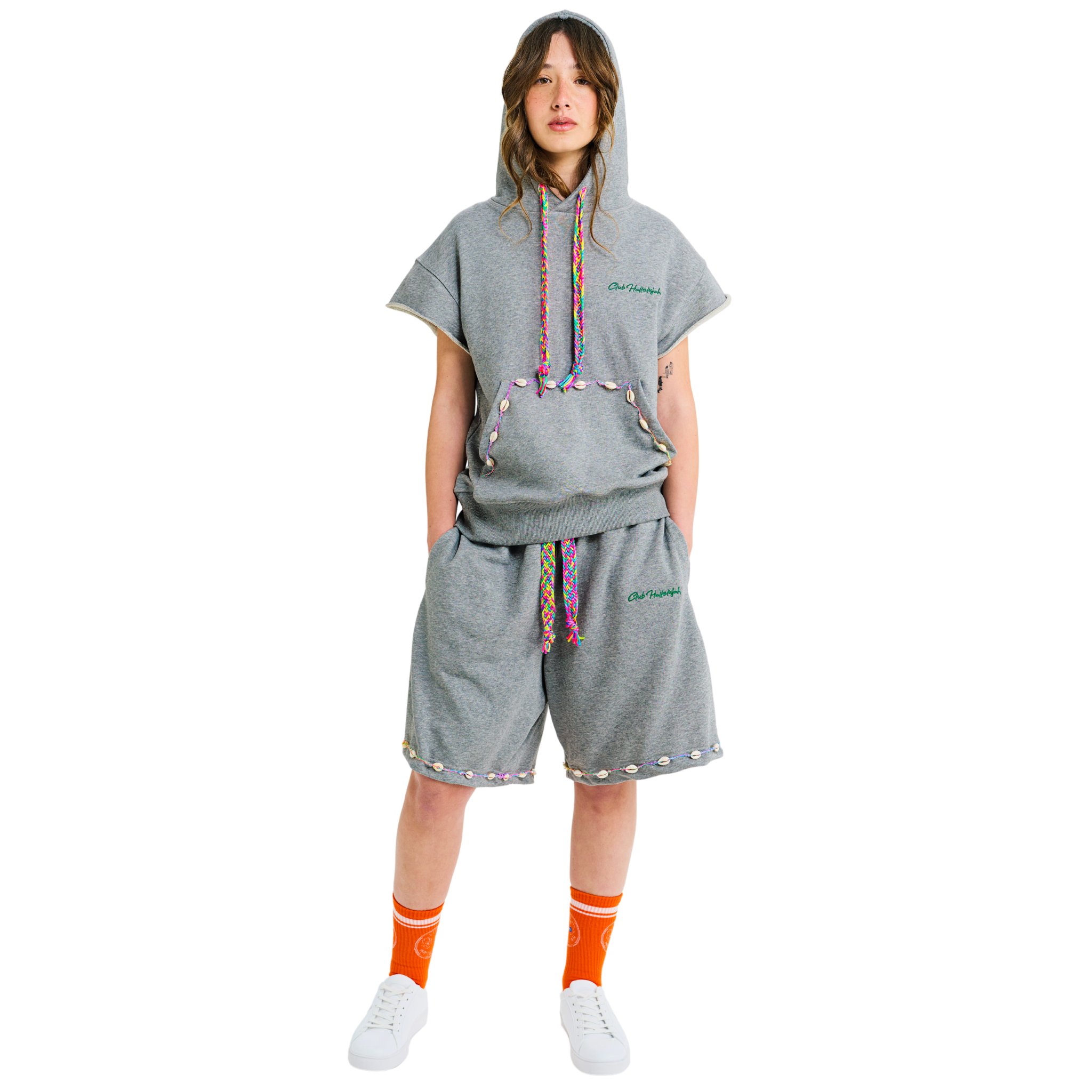 Female model wearing unisex gray melange short-sleeved hoodie, 100% cotton, handmade cowrie shells, handwoven drawstring, Club Hallelujah logo