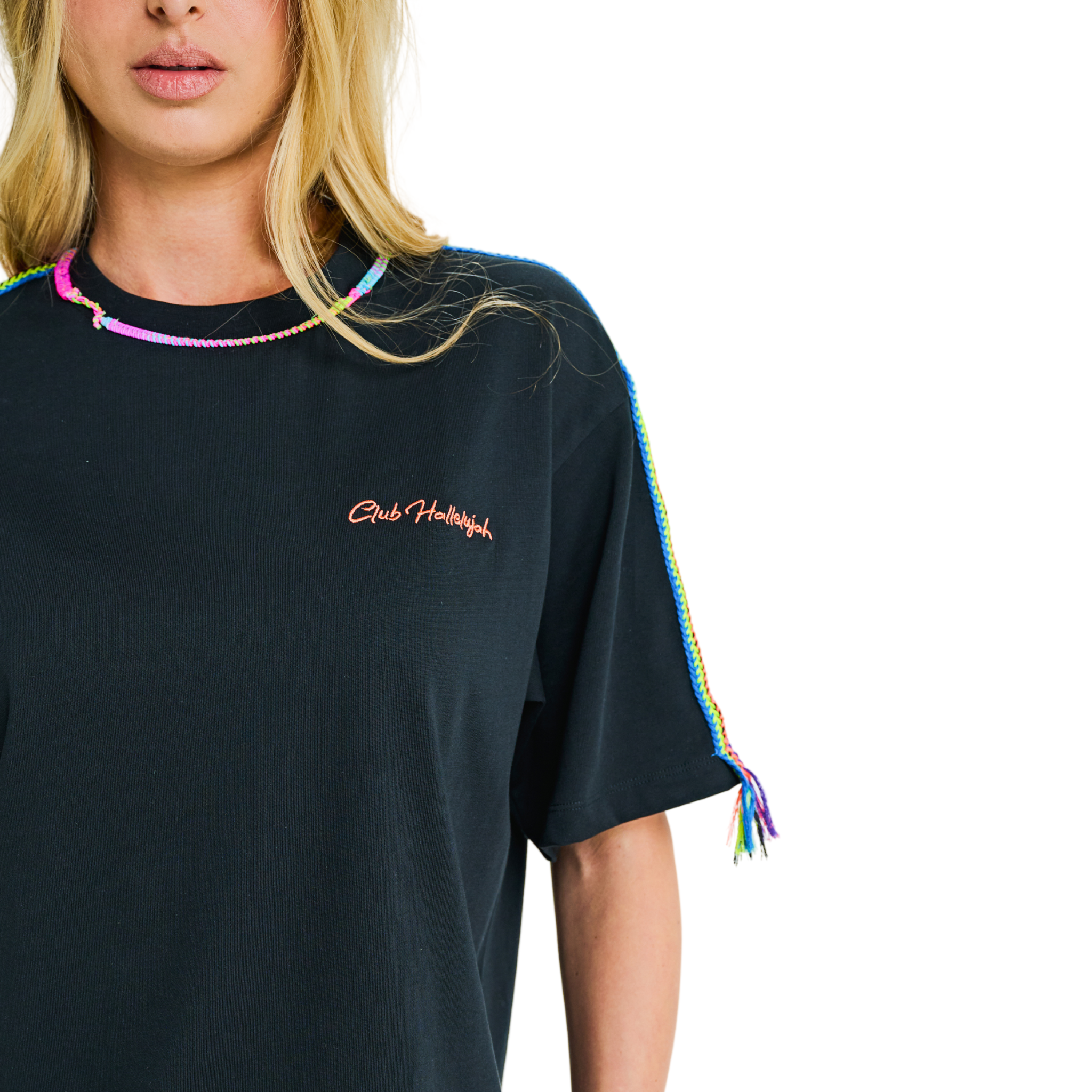 Close-up of embroidered chest logo and handmade braided multicolor details on black oversized T-shirt neckline