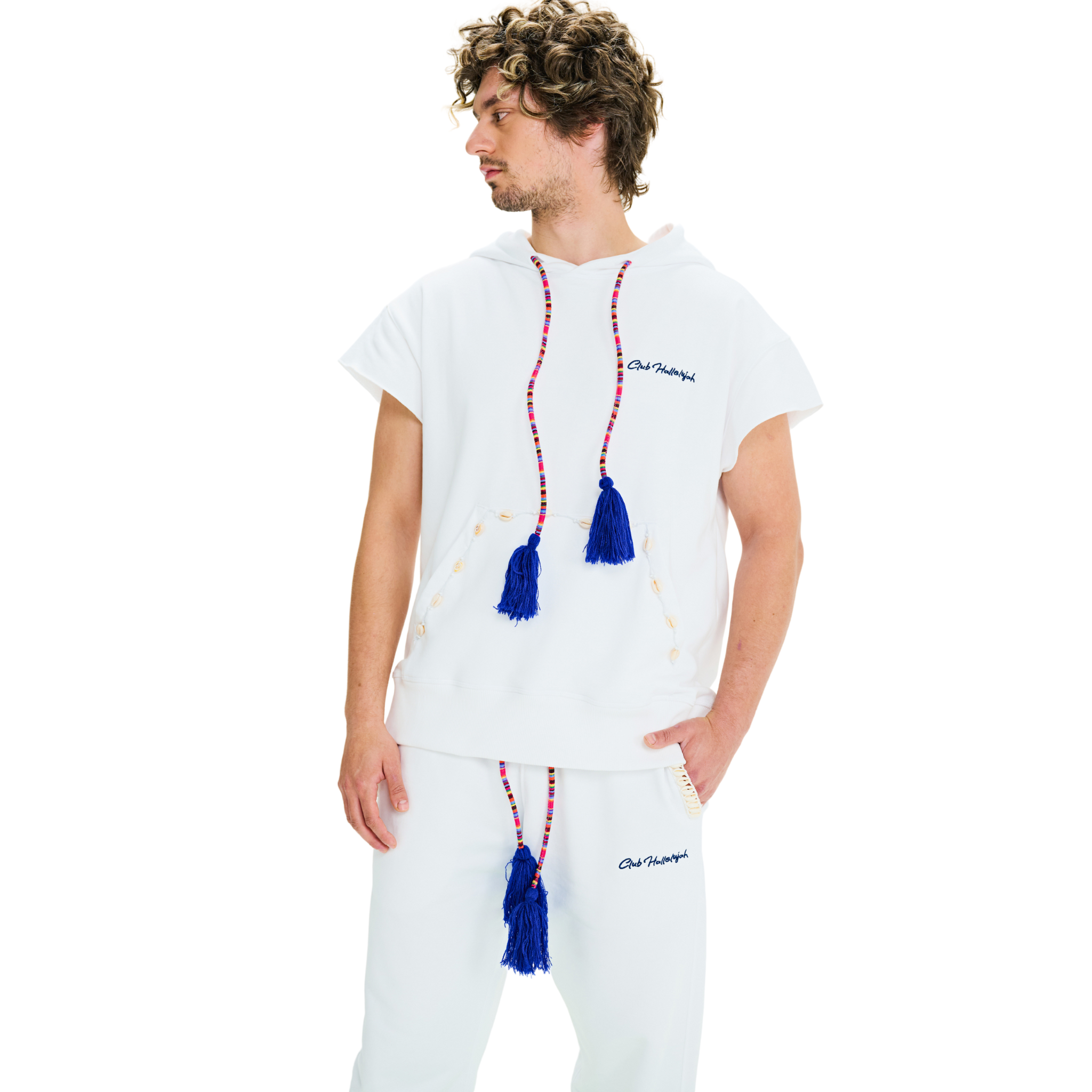 Side view of male model wearing unisex white hoodie with blue tassels and cowrie shell pocket trim