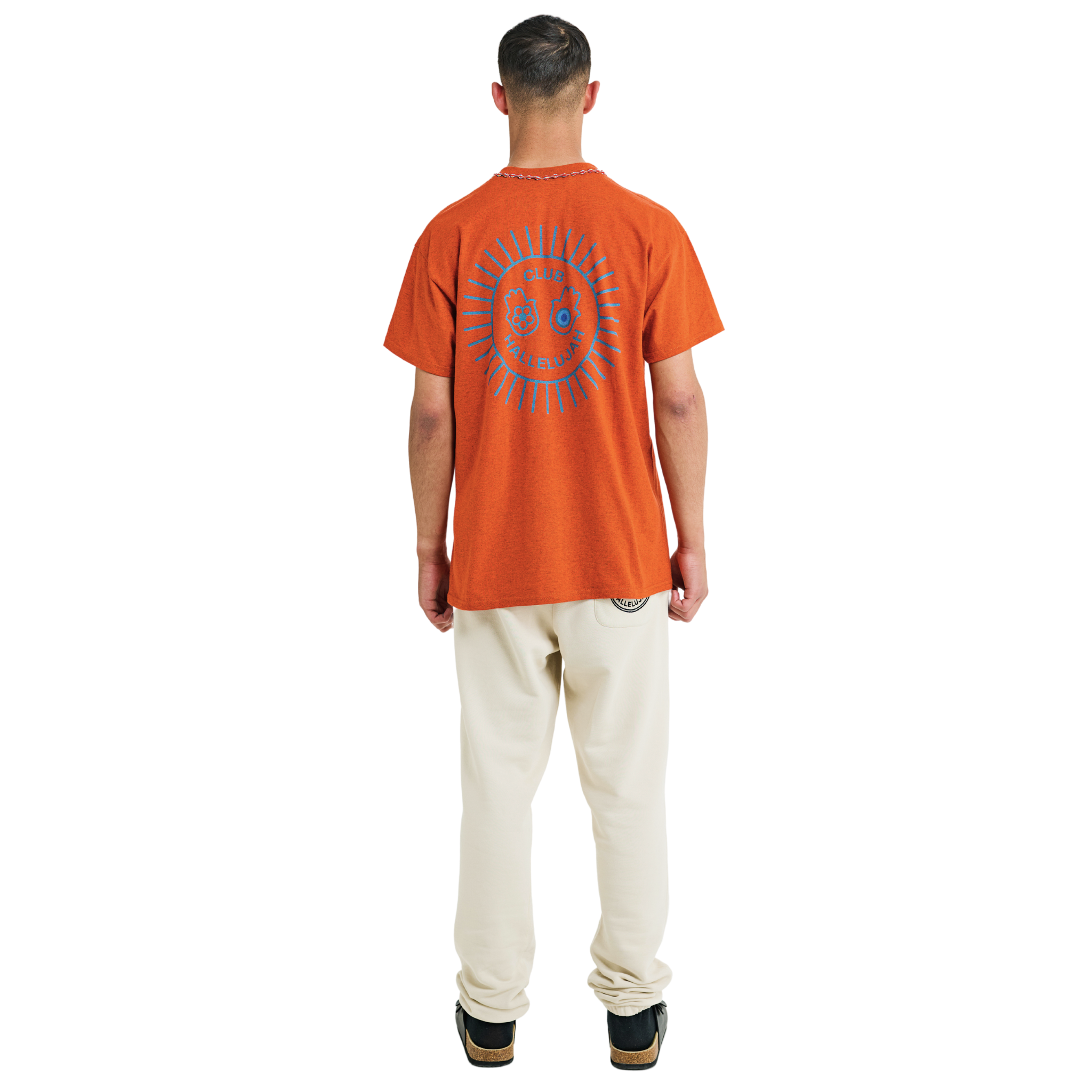 Male model wearing orange mélange T-shirt, back view, showing blue sunburst print and braided neckline