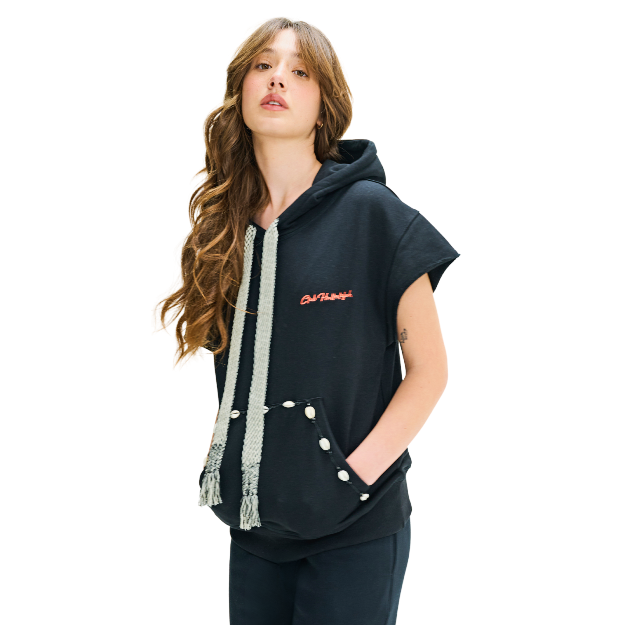 Female model front view in Mogador Nights short-sleeve hoodie with woven straps and cowrie shells