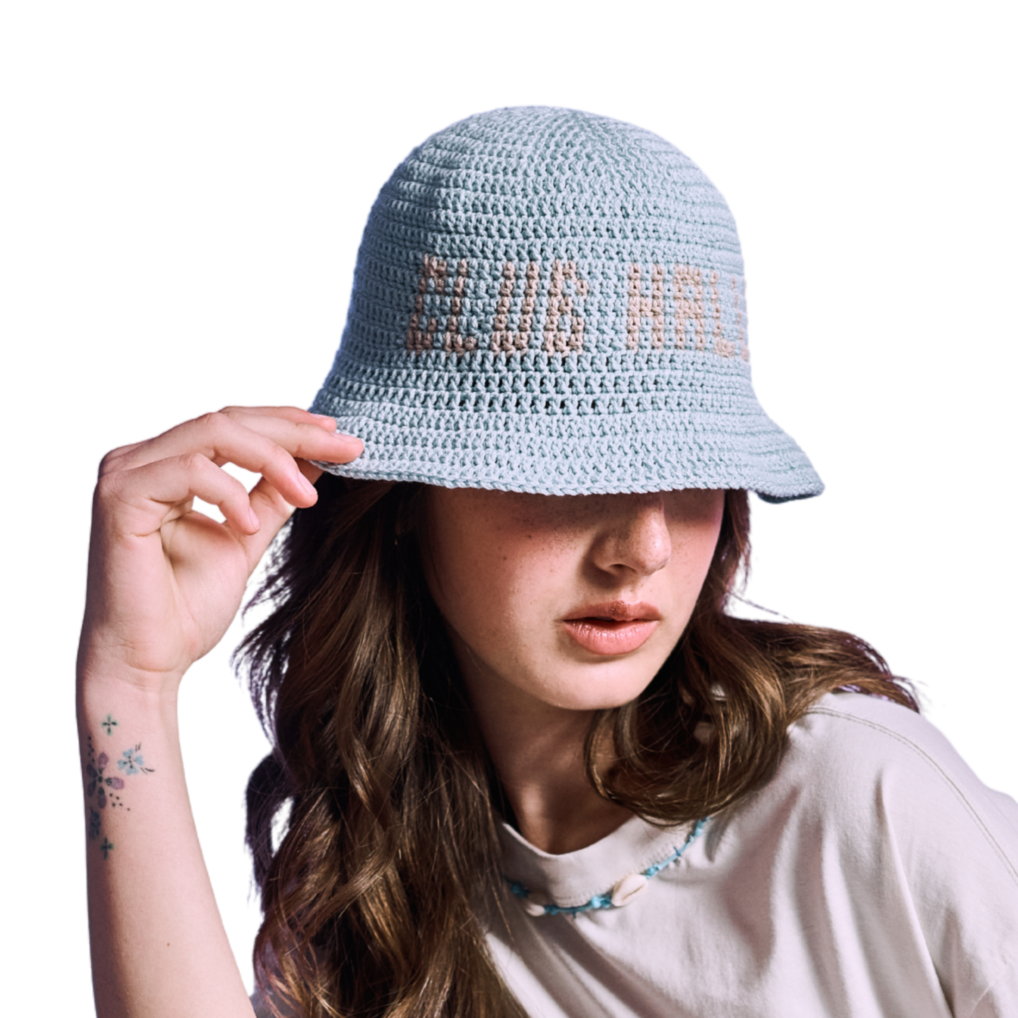 Model wearing baby blue crocheted bucket hat with orange 'CLUB HALLELUJAH' text, side view
