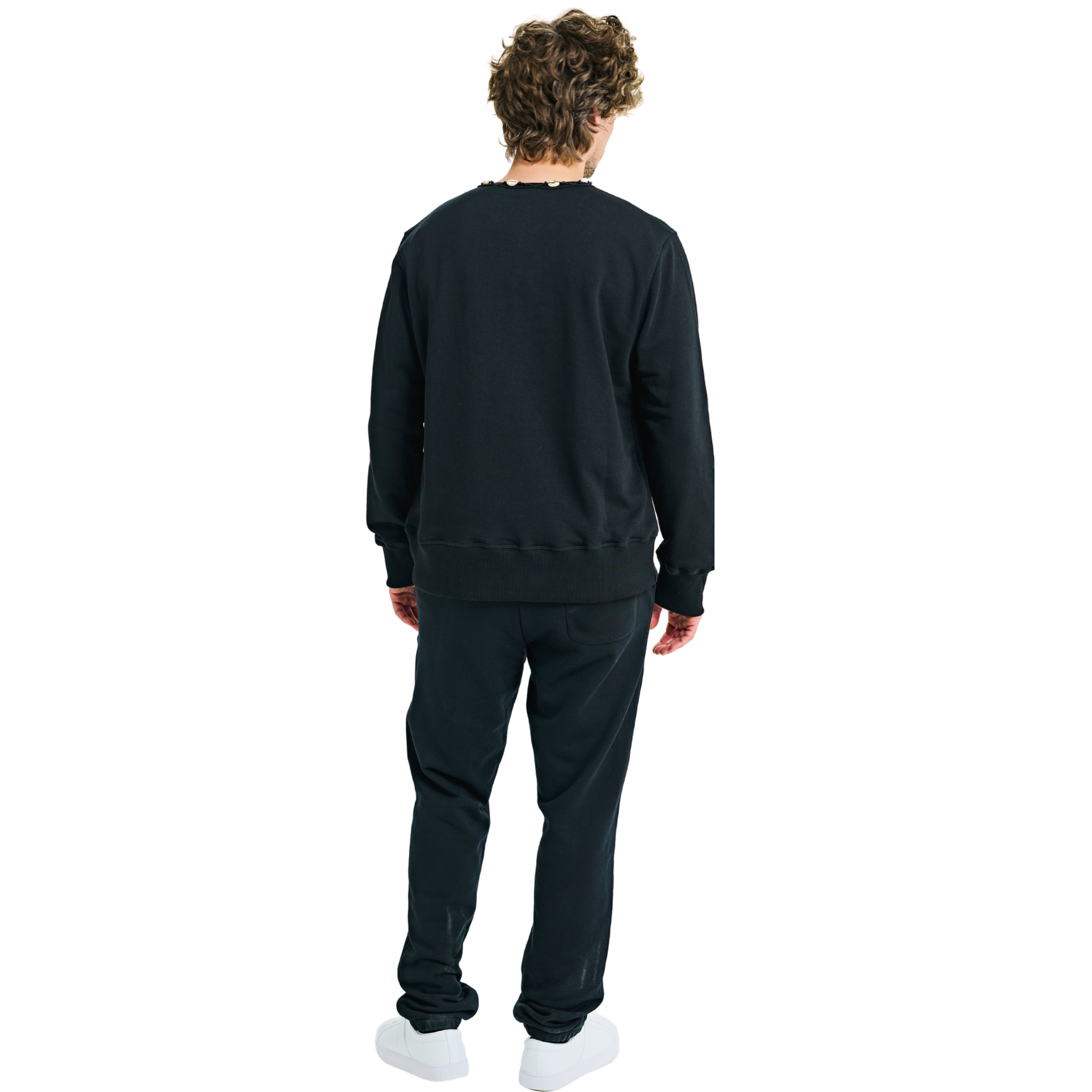 Back view of male model wearing unisex black sweatshirt with handmade braided shell-trimmed neckline and clean lines