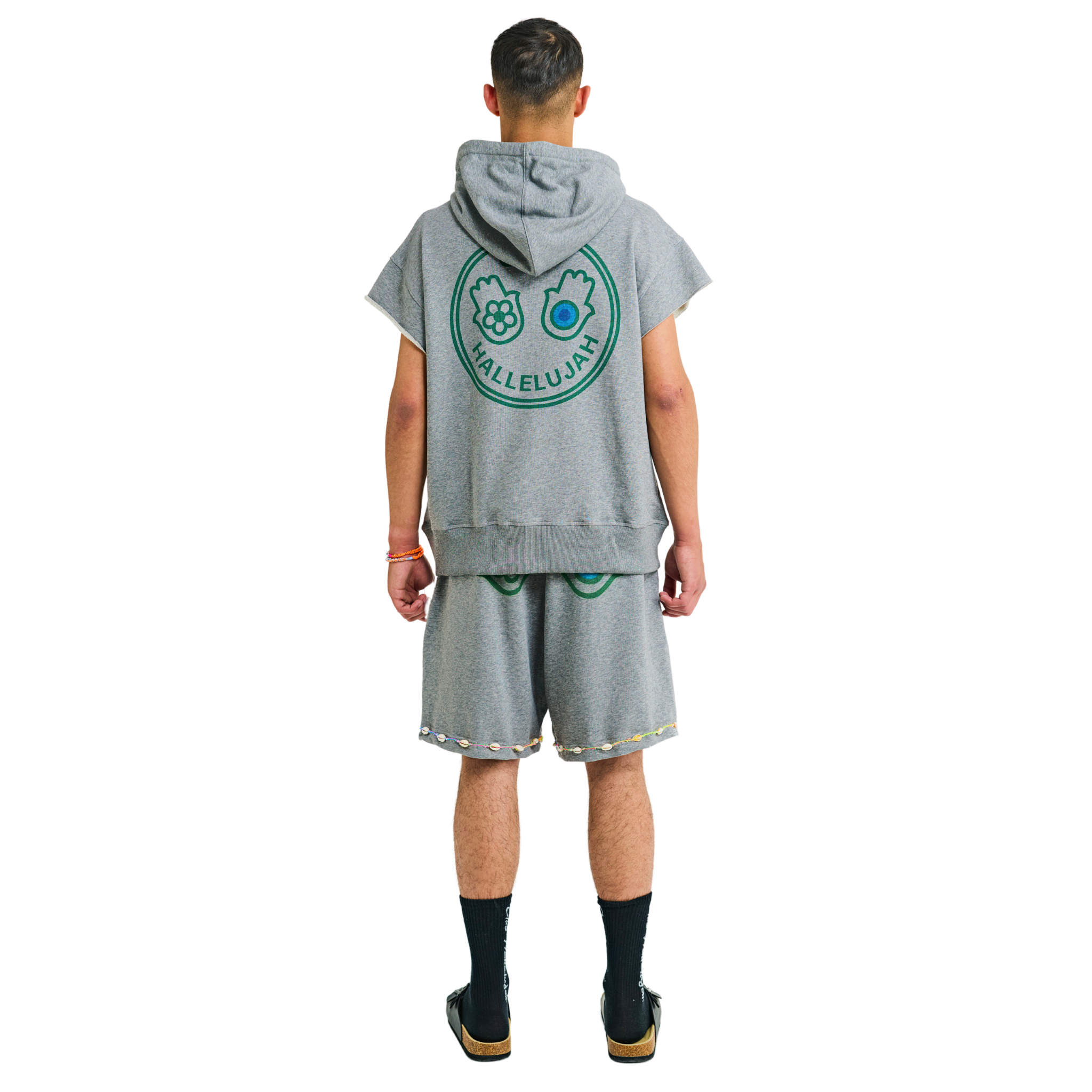 Male model showing back of unisex gray melange hoodie with Club Hallelujah hamsa hands logo, handmade details, 100% cotton, cowrie shells