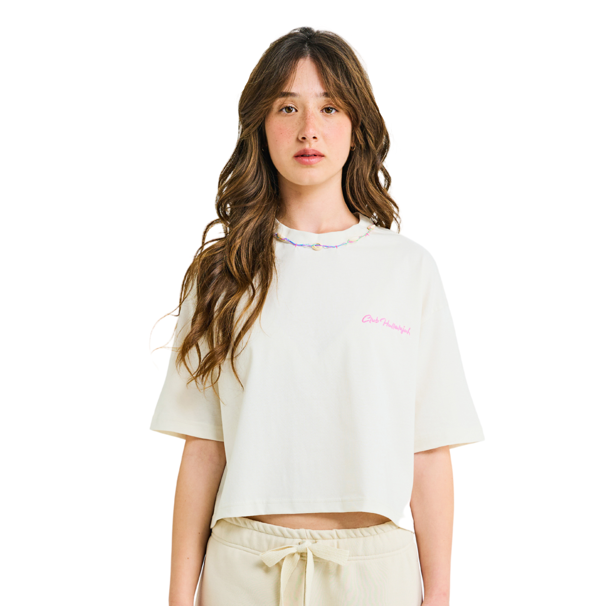 Model in oat milk crop top, front view, showing pink embroidery and cowrie shell neckline, close-up