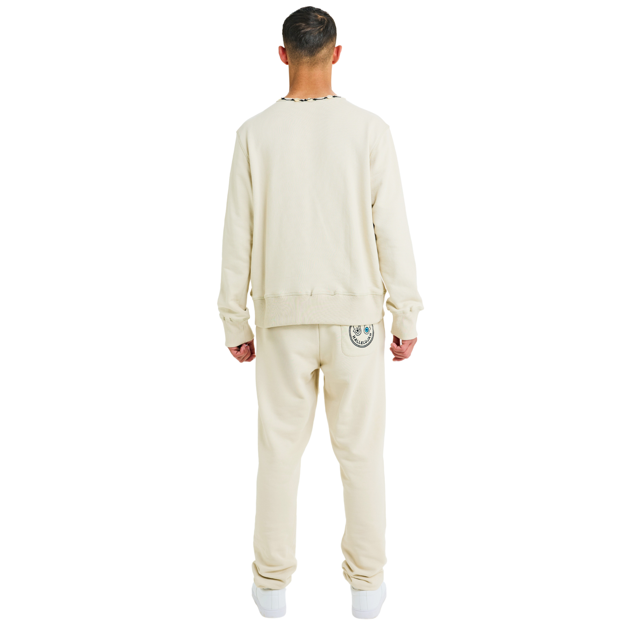 Back view of male model wearing unisex stone sweatshirt with braided shell-trimmed neckline and clean handmade details