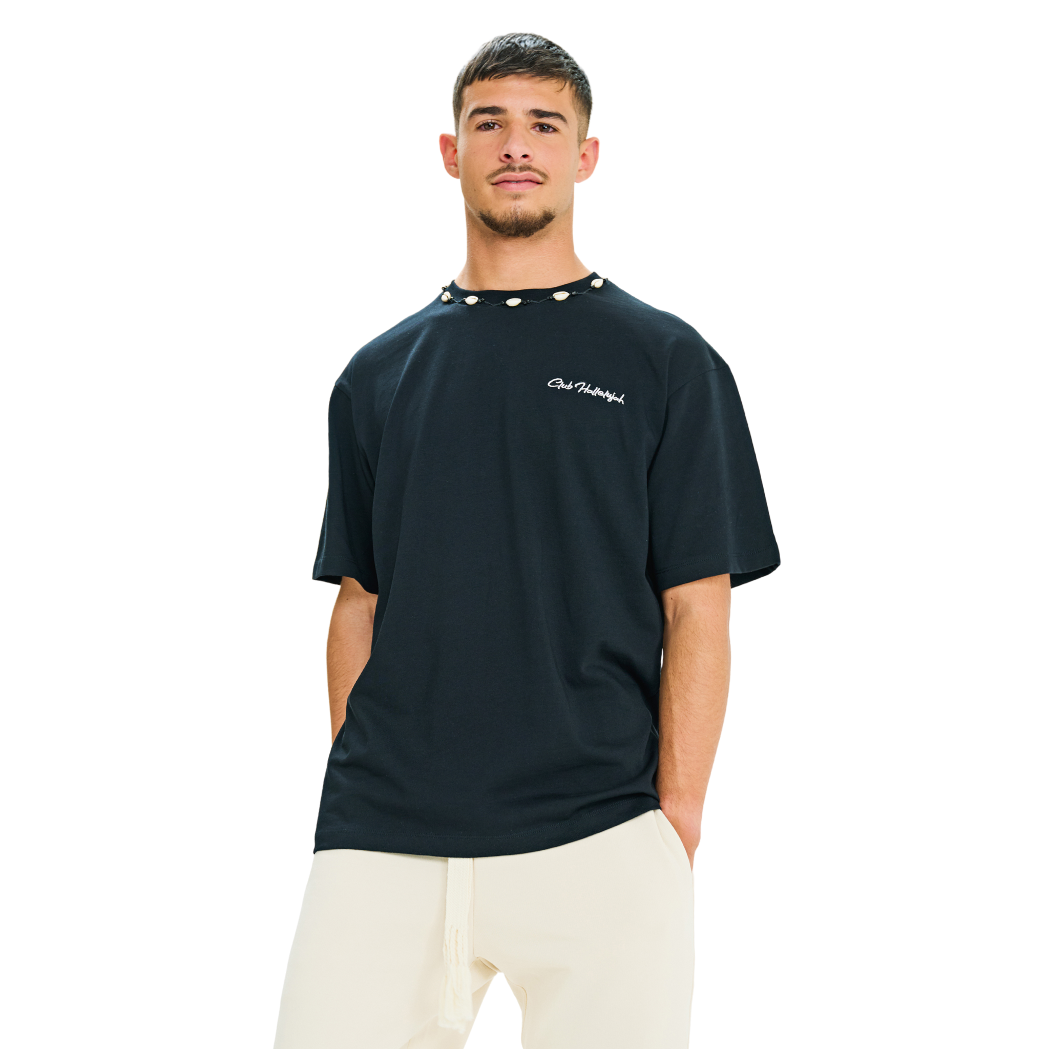 Front view of male model wearing unisex black oversized T-shirt with embroidered logo and braided shell neckline
