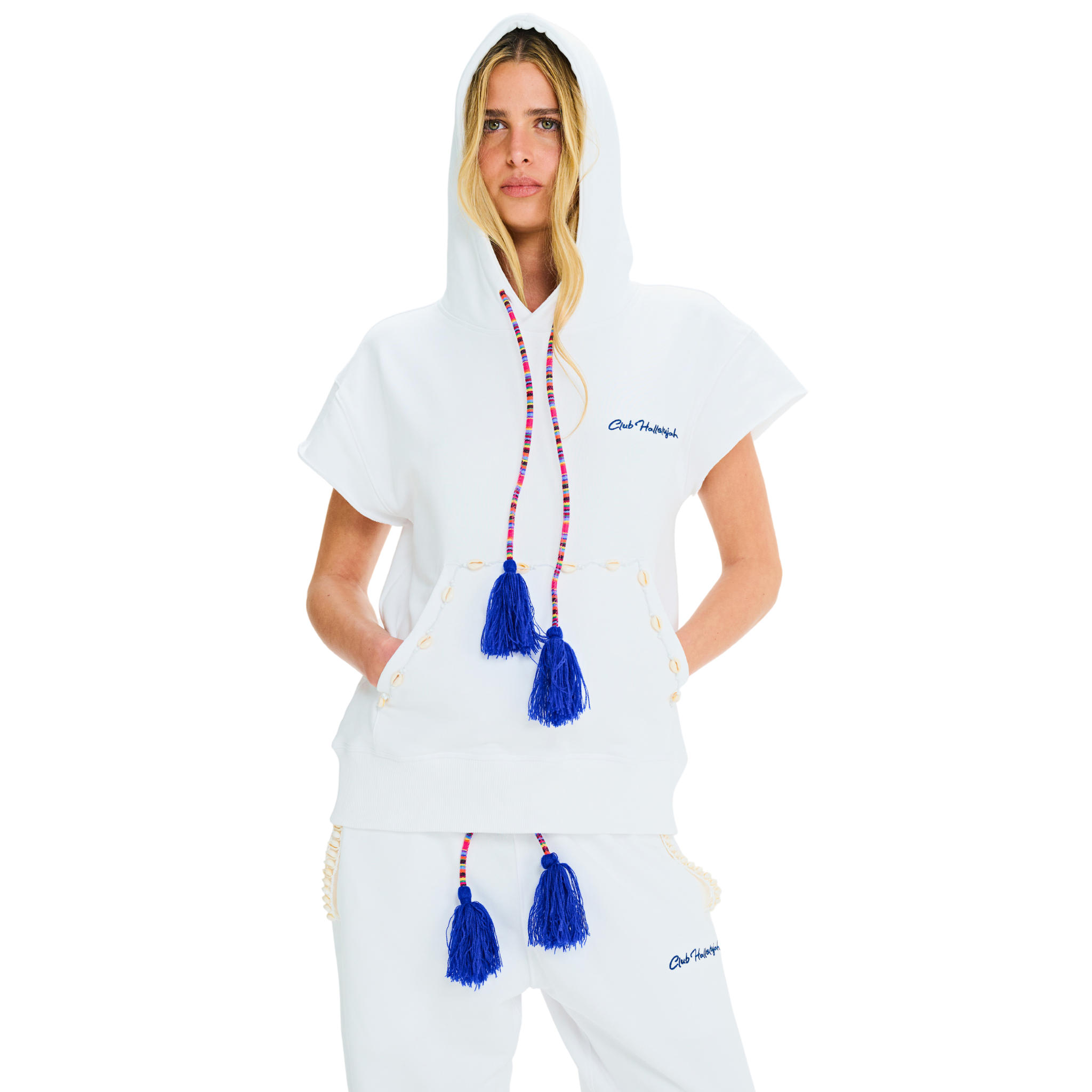 Front view of female model wearing unisex white short-sleeved hoodie with cowrie shells and blue tassel drawstring