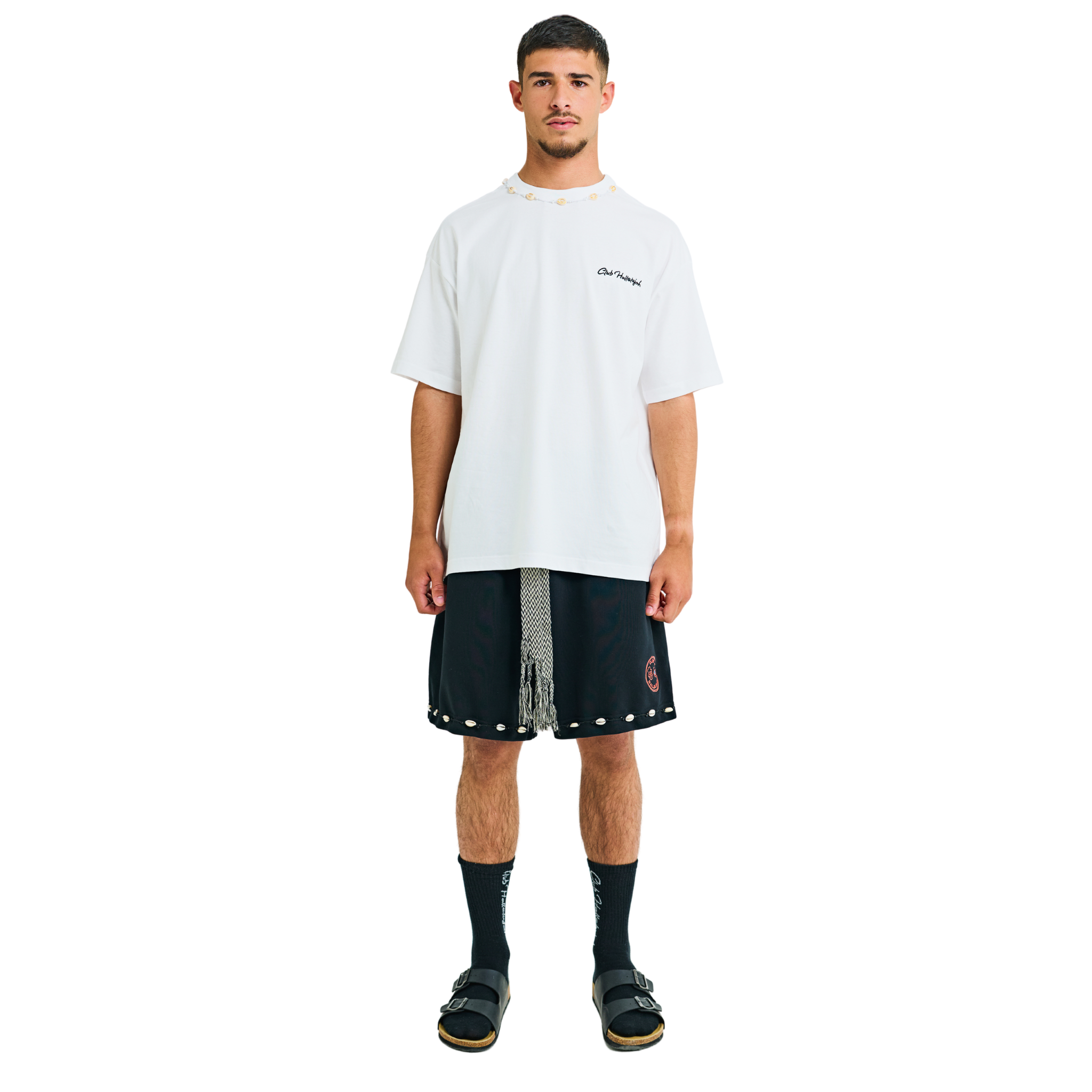 Model wearing white T-shirt with small front logo and cowrie shell neckline, front view