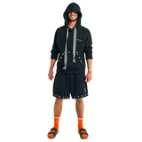 Male model front view wearing embroidered long-sleeve hoodie with handmade cowrie shells and braided tassels