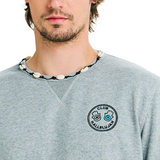 Close-up of embroidered logo on chest and handmade braided shell neckline on grey mélange sweatshirt