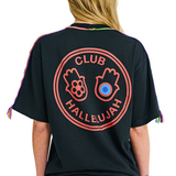 Back view of female model in black oversized T-shirt with printed graphic logo and braided shoulder details