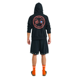 Back view of male model in long-sleeve hoodie with large embroidered graphic, handmade details, and woven hood straps