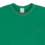Close-up of green mélange T-shirt neckline with handmade braided ribbon and small front logo