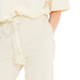 Close-up of woven cotton drawstring waist and soft French terry fabric on stone classic sweatpants