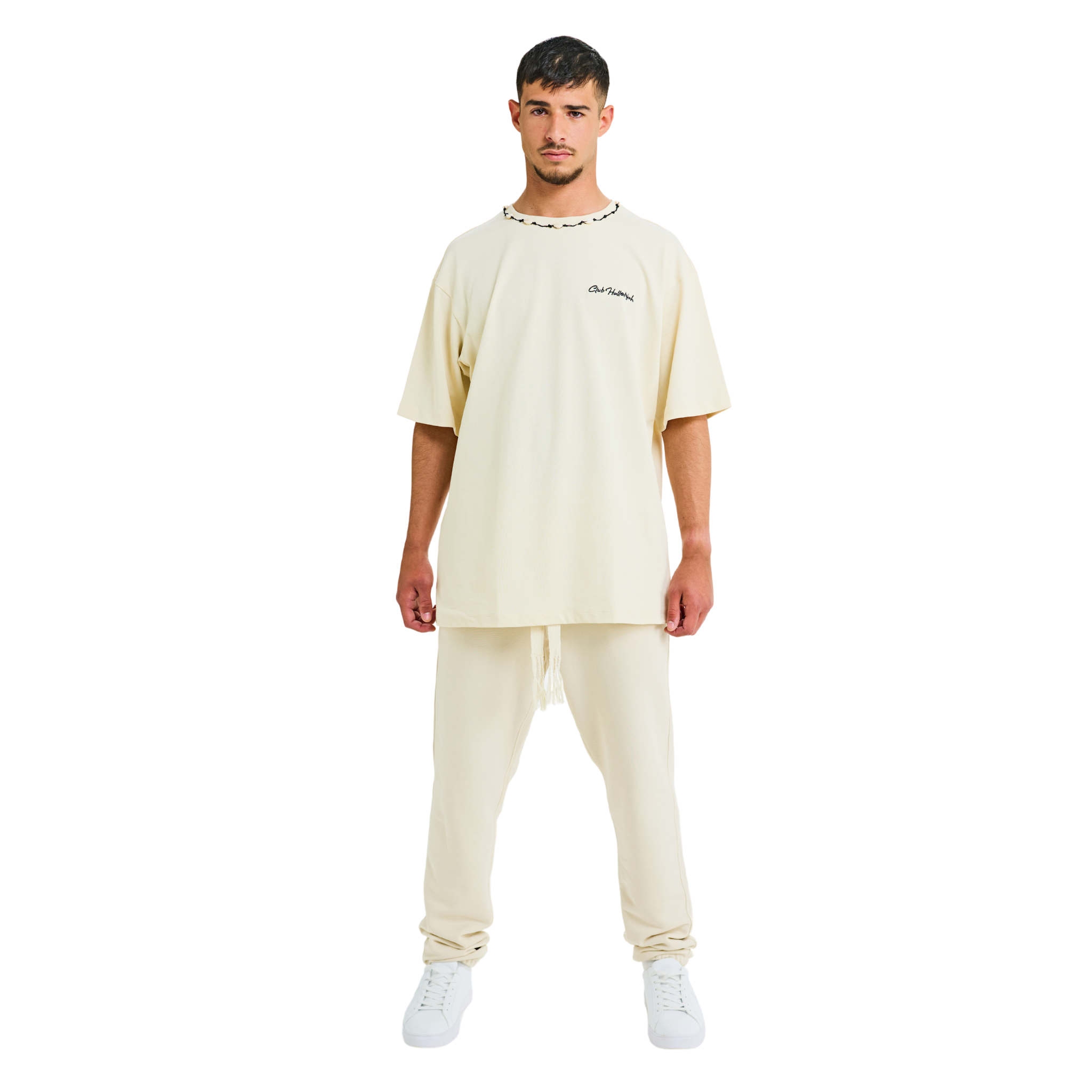Front view of male model wearing unisex sabbia oversized T-shirt with embroidered logo and braided shell neckline