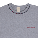 Close-up of ash grey mélange T-shirt neckline with handmade braided ribbon and small front logo