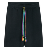 Close-up of braided neon drawstrings crafted by hand on unisex black sweatpants with classic straight-leg fit