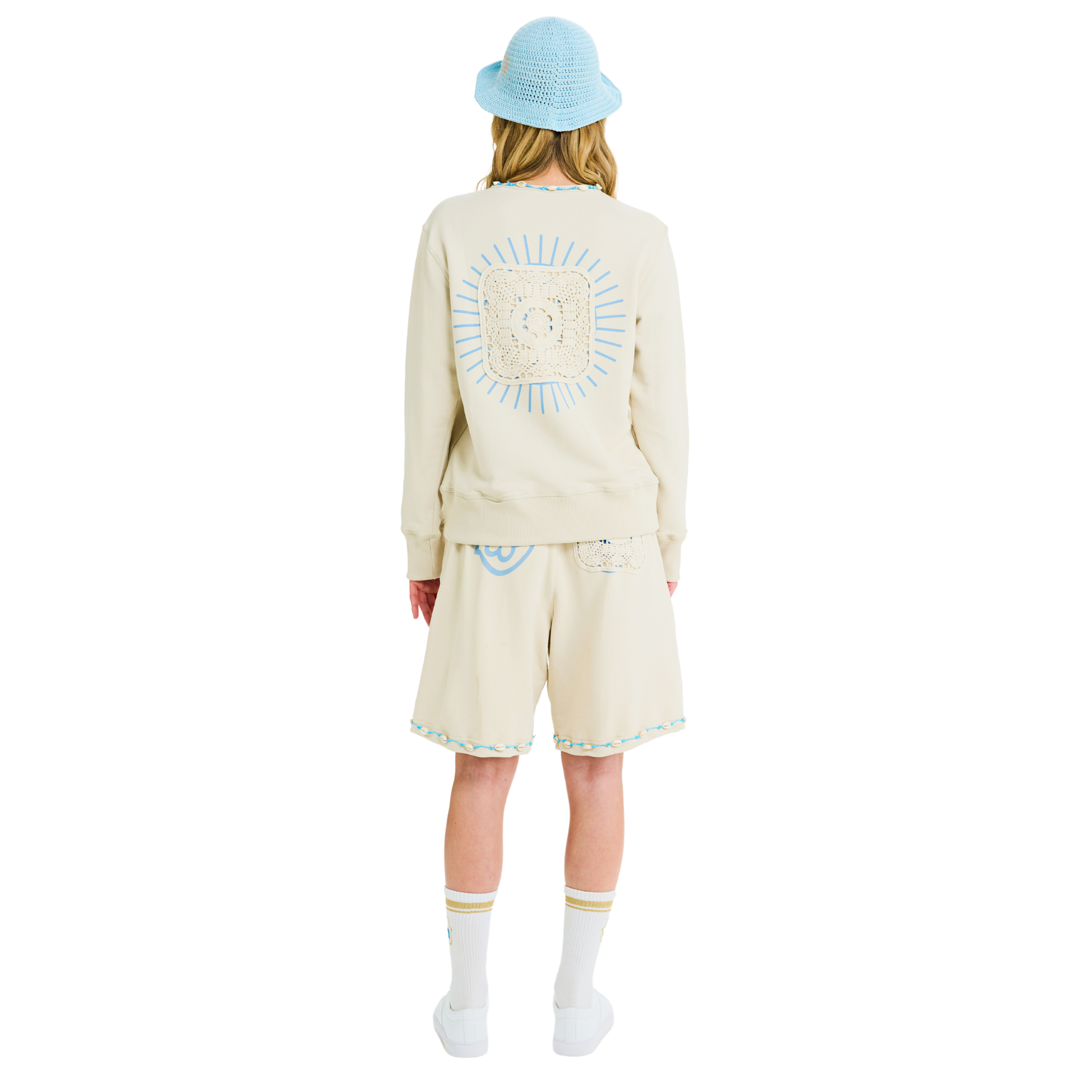 Female model back view wearing unisex stone sweatshirt, 100% cotton, handmade lace detail, sunburst back print