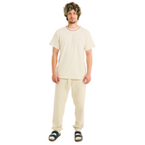 Male model wearing natural cotton T-shirt with small front logo and braided neckline, front view, full body