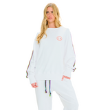 Female model front view in white oversized sweatshirt with embroidered logo and braided handmade sleeve details