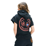 Back view of female model in Mogador Nights hoodie with large hamsa graphic print, short sleeves, and hood