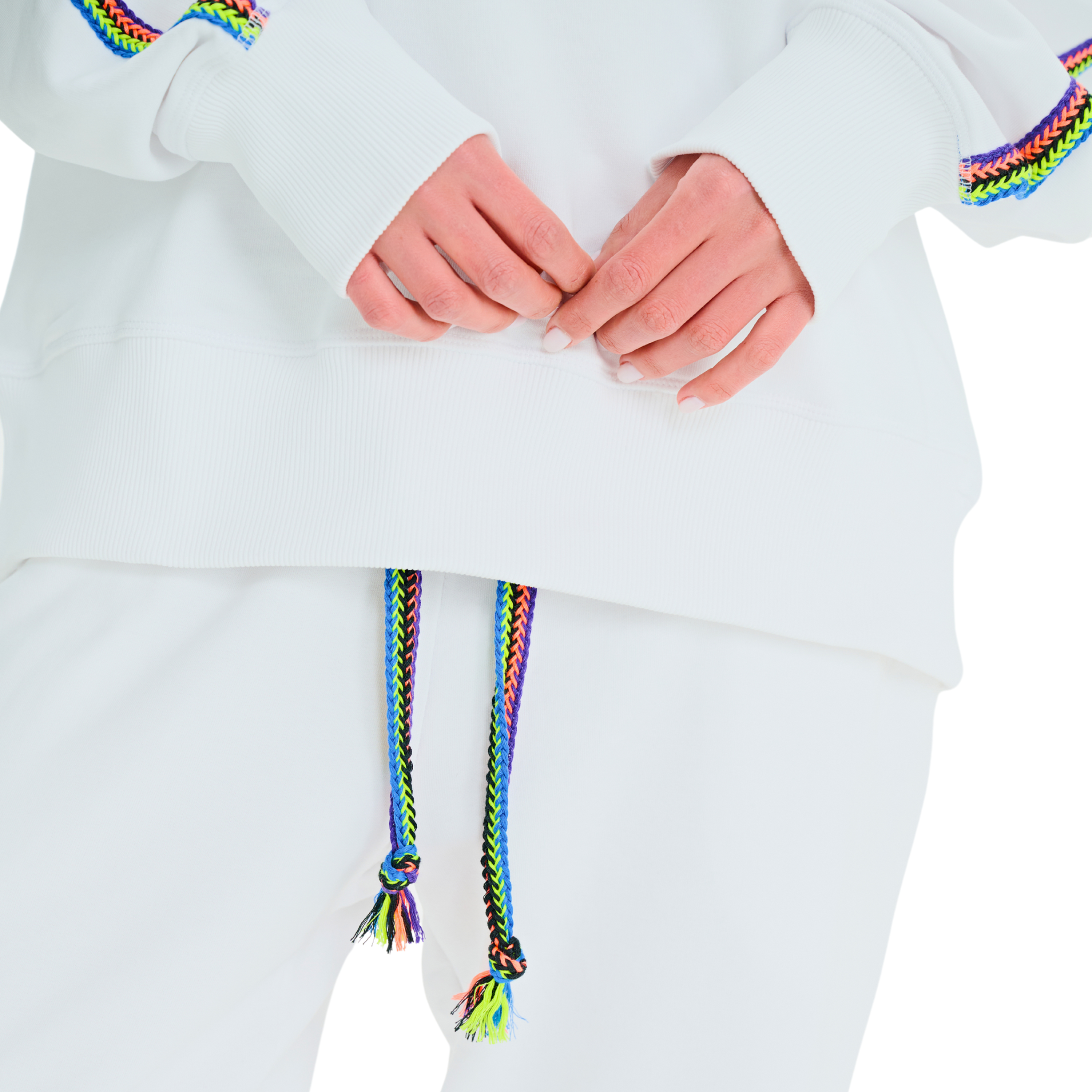 Close-up of handmade multicolor braided sleeve and drawstring details on white oversized sweatshirt and pants