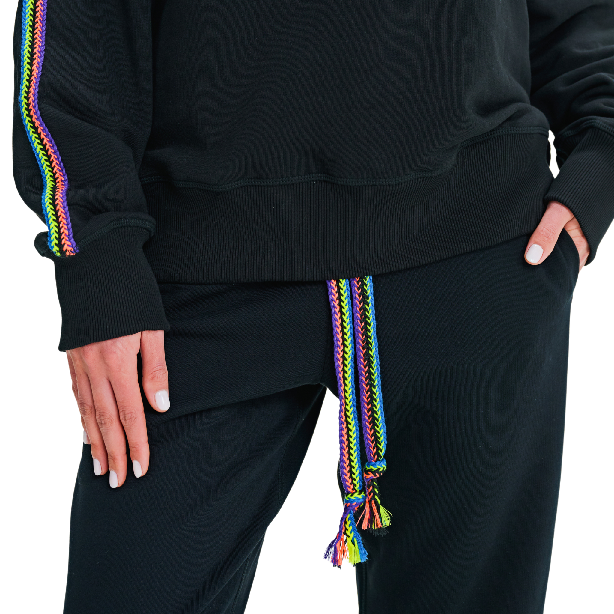 Close-up of handmade braided multicolor sleeve detail and braided drawstring at waist on black oversized sweatshirt and pants