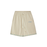 Unisex stone cotton shorts, embroidered Club Hallelujah logo, handmade drawstring with tassels, cowrie shell trim at hem