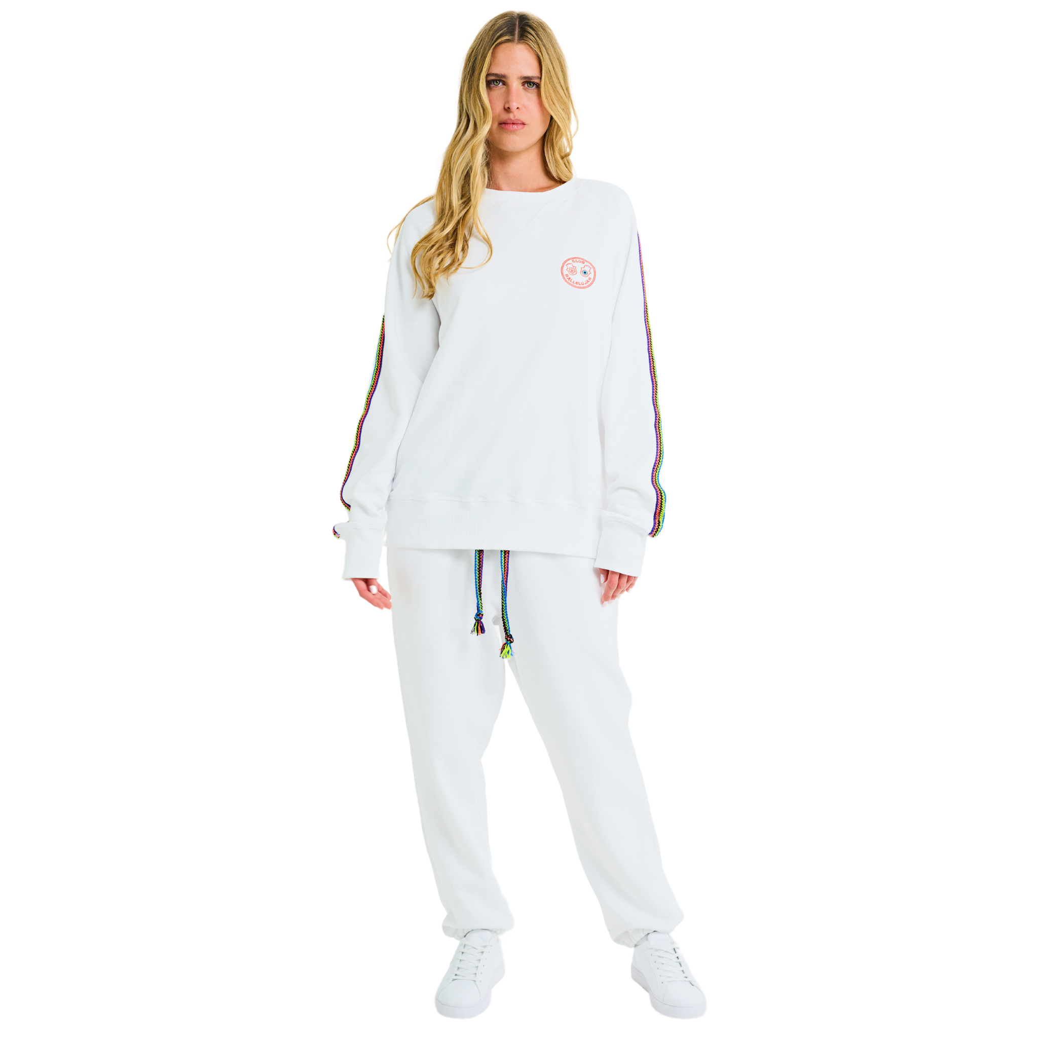 Full front view of female model in white oversized sweatshirt with embroidered logo and handmade sleeve details
