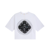 White organic cotton crop top, back view, with black sunburst appliqué and cowrie shell neckline