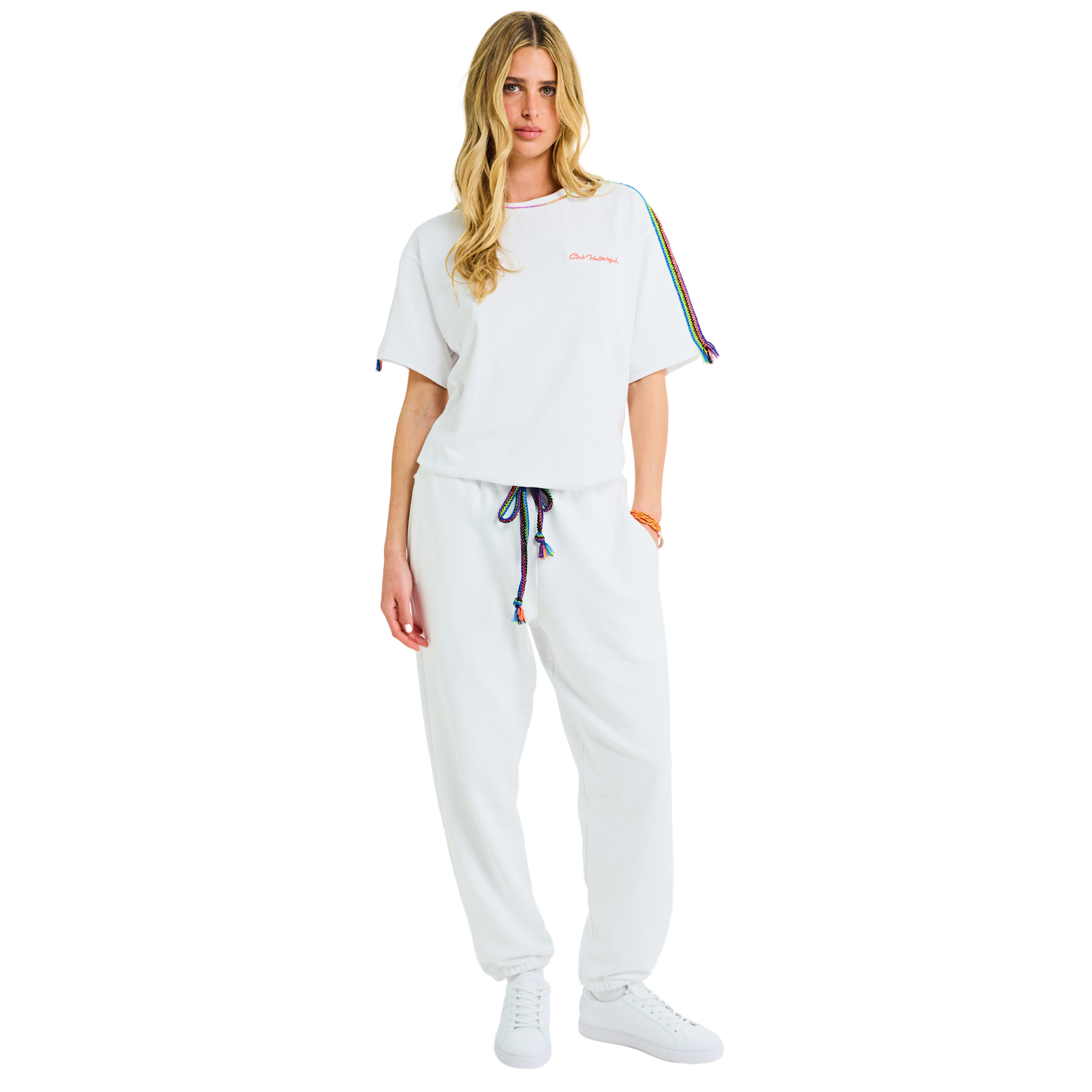 Front view of female model wearing unisex Tokyo Hero white oversized T-shirt with embroidered logo and handmade braided multicolor shoulders
