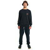 Male model front view wearing black oversized sweatshirt with embroidered logo and braided sleeves
