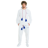 Front view of male model wearing unisex white hoodie and sweatpants, 100% cotton, handmade drawstrings with blue tassels, cowrie shell details, Club Hallelujah logo embroidery
