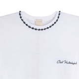 Close-up of white T-shirt neckline with handmade braided ribbon and small 'Club Hallelujah' logo