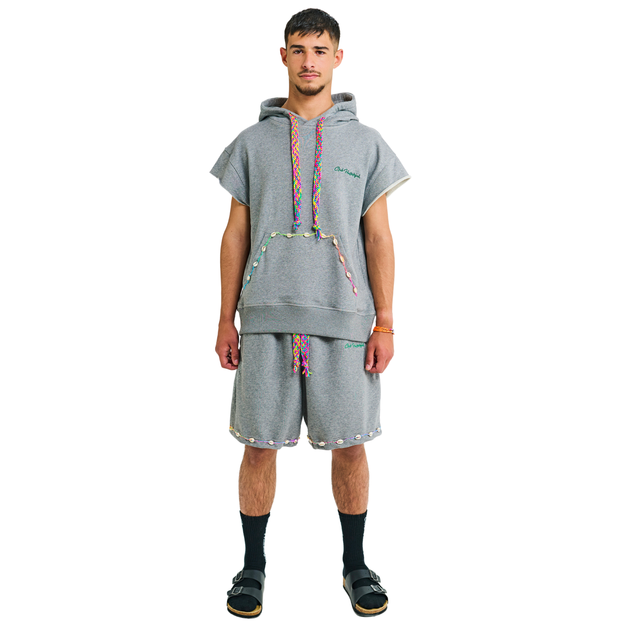 Male model wearing unisex gray melange short-sleeved hoodie with handmade cowrie shells, handwoven drawstring, 100% cotton, Club Hallelujah logo