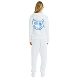Female model back view in unisex white hoodie, Club Hallelujah hamsa hands print, handmade details, cowrie shells, 100% cotton