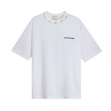 White oversized T-shirt with pink 'Club Hallelujah' embroidery and cowrie shell neckline, front view