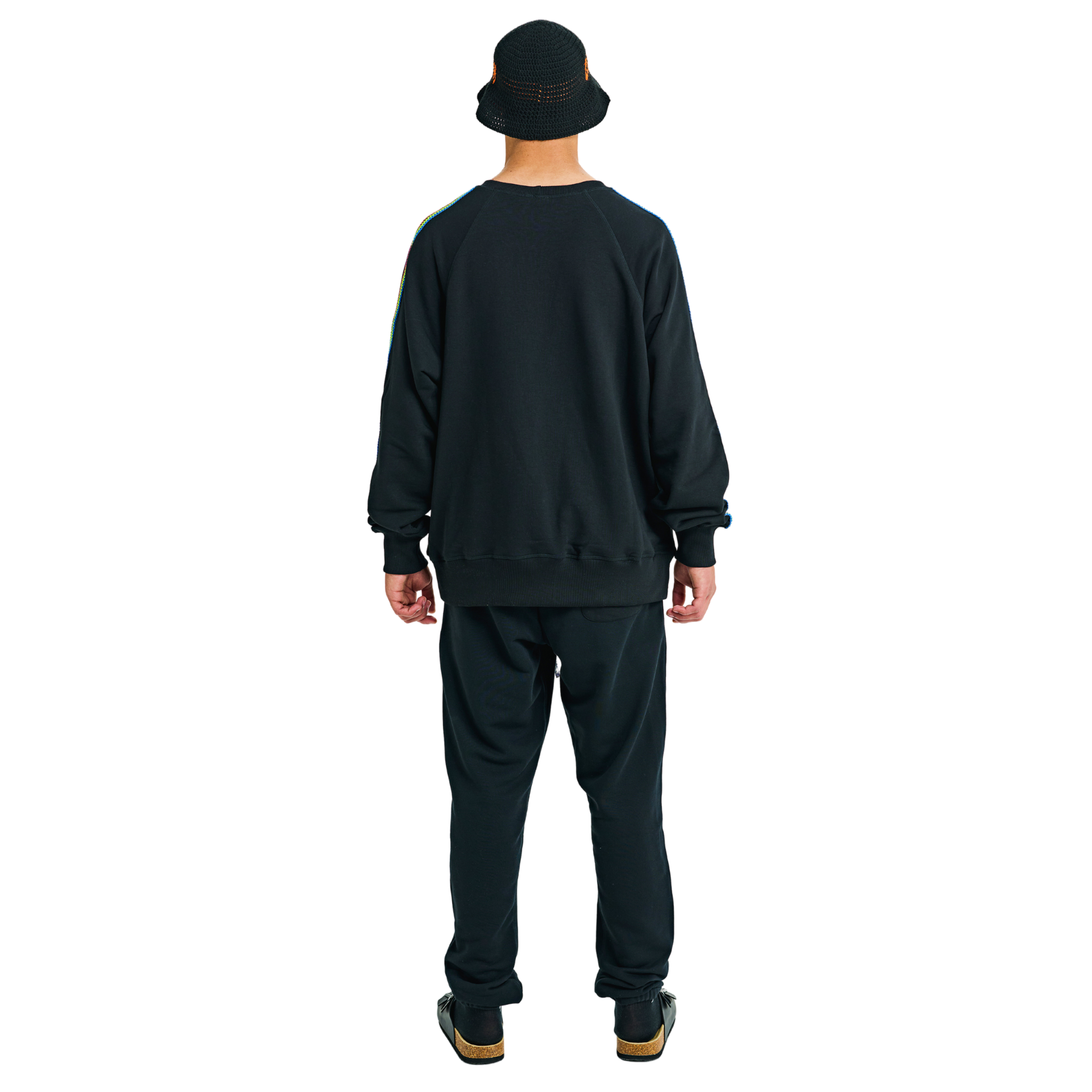 Back view of male model in black oversized raglan sweatshirt with plain back and handmade braided sleeves