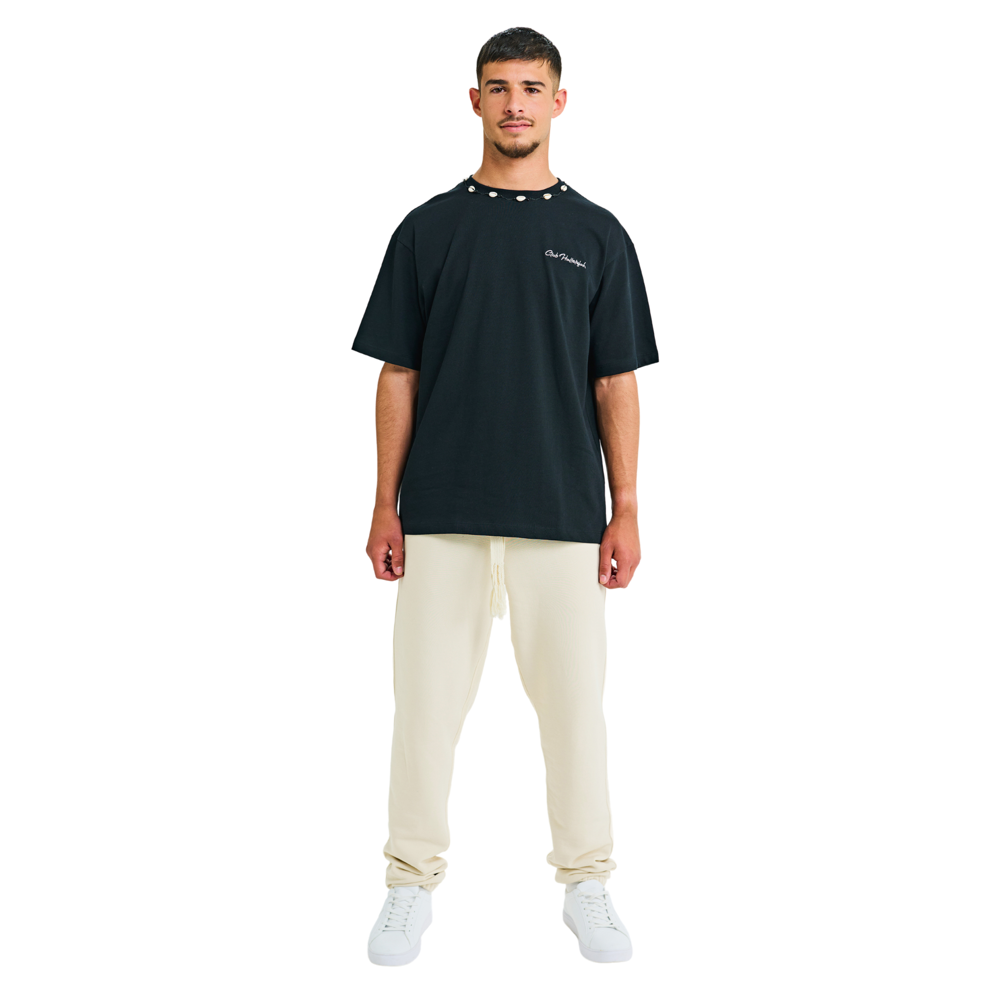 Front view of male model in unisex black oversized T-shirt with embroidered logo and handmade braided neckline