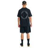 Model wearing black T-shirt, back view, showing sunburst appliqué and cowrie shell neckline