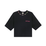 Black organic cotton crop top with pink 'Club Hallelujah' embroidery and cowrie shell neckline, front view