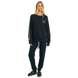 Female model front view in black oversized sweatshirt with embroidered logo and handmade details