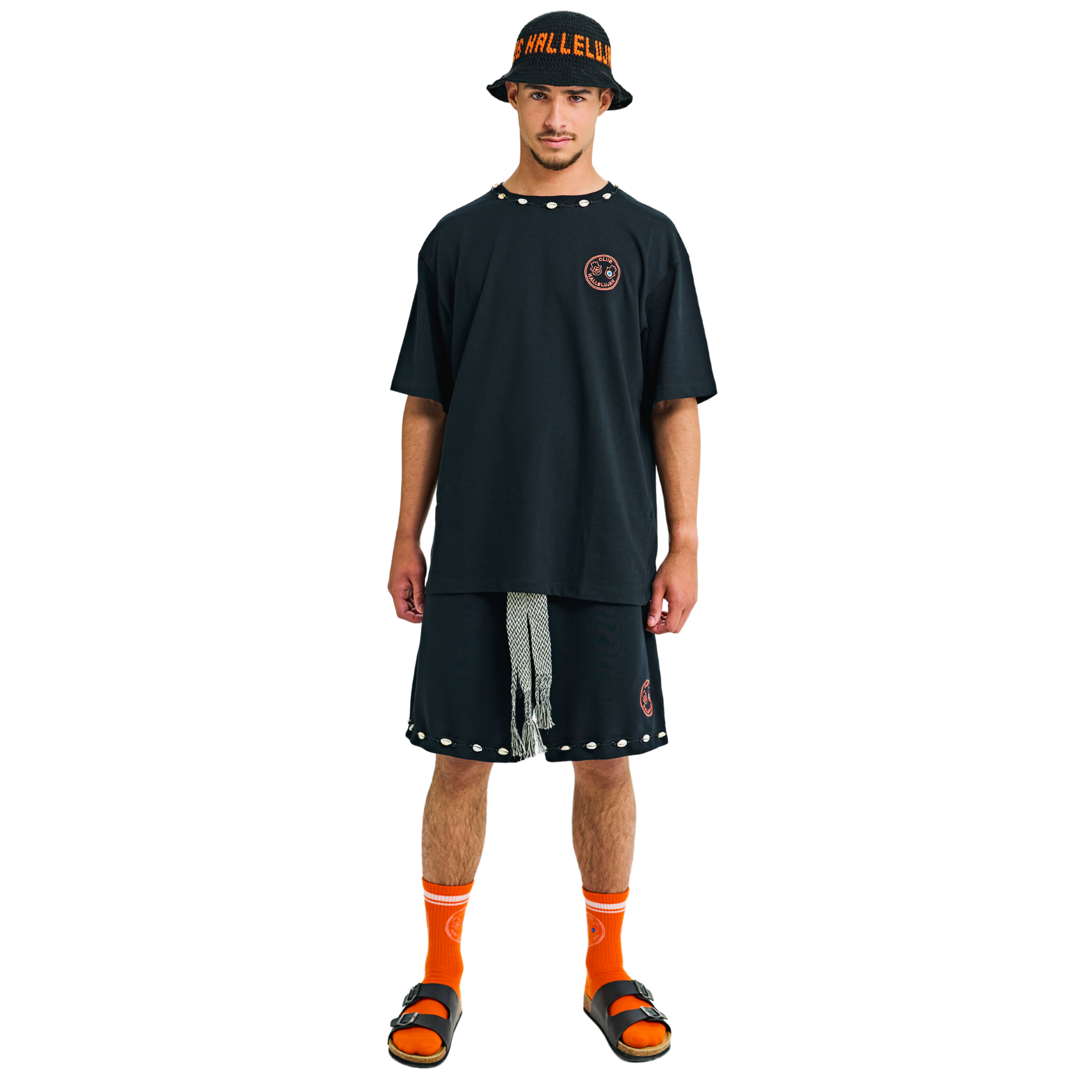 Male model wearing black oversized T-shirt with small front logo and braided neckline, front view