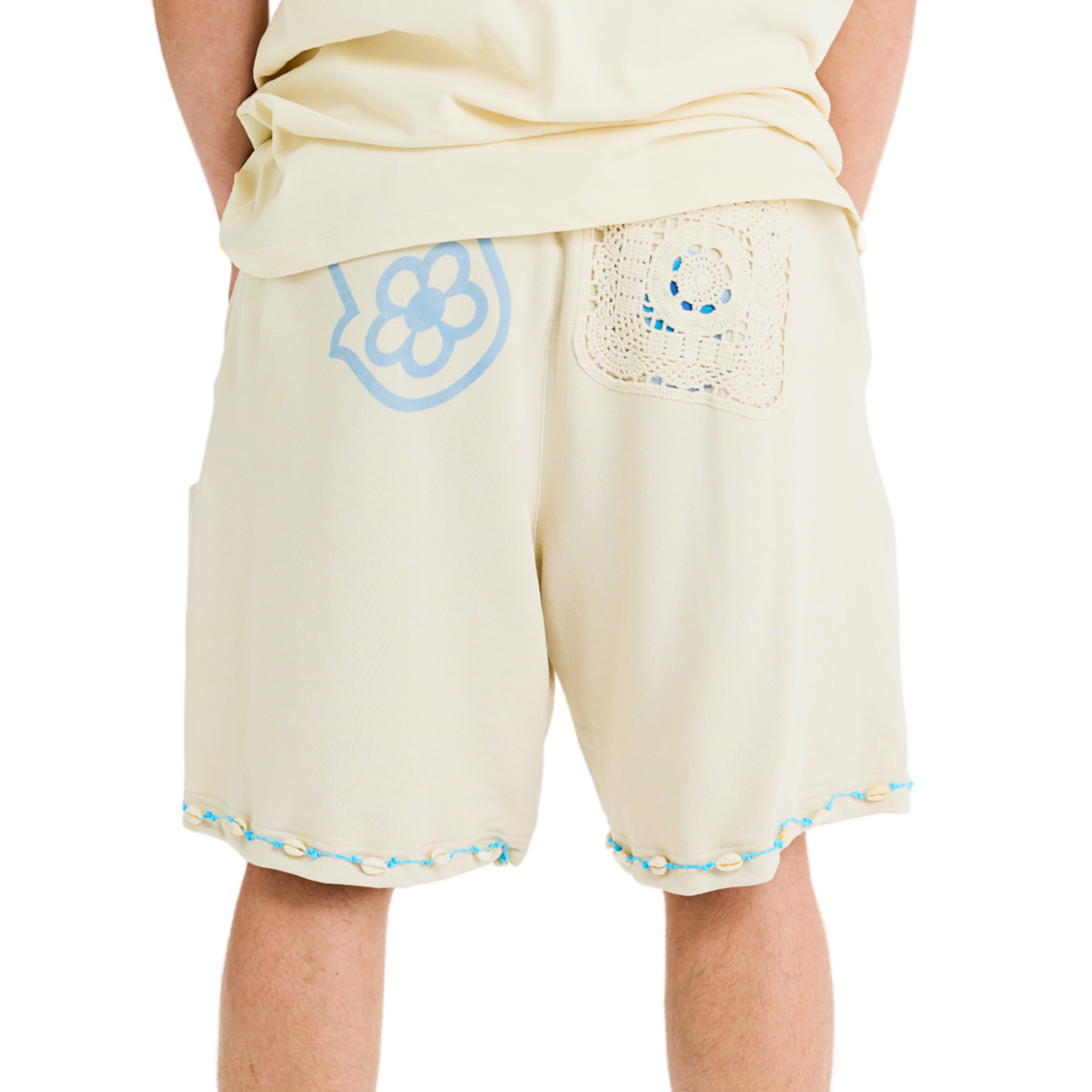 Back view unisex shorts, crochet lace hand patch, cowrie shells along hem, handmade details, relaxed fit